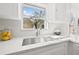 Close up of stainless steel kitchen sink with white countertops and cabinets and nice backyard views at 2328 Dartmouth N Ave, St Petersburg, FL 33713