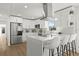 A beautifully renovated kitchen features new stainless steel appliances, white cabinetry, and a large island with bar stool seating at 2328 Dartmouth N Ave, St Petersburg, FL 33713