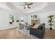 Bright living room with fireplace, tray ceiling, ceiling fan, hardwood floors, and stylish furnishings at 2328 Dartmouth N Ave, St Petersburg, FL 33713
