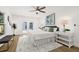 A spacious main bedroom with french doors, hardwood floors, a ceiling fan, and tasteful decorations at 2328 Dartmouth N Ave, St Petersburg, FL 33713