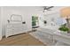 A spacious main bedroom with french doors, hardwood floors, a ceiling fan, and tasteful decorations at 2328 Dartmouth N Ave, St Petersburg, FL 33713
