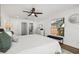 A spacious main bedroom with hardwood floors, a ceiling fan, and ensuite bathroom with plenty of natural light at 2328 Dartmouth N Ave, St Petersburg, FL 33713