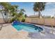 A serene pool nestled among lush palm trees and a privacy fence, perfect for relaxation and outdoor enjoyment at 2328 Dartmouth N Ave, St Petersburg, FL 33713