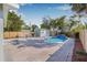 Beautiful backyard with a sparkling pool, brick pavers, mature landscaping, and a charming pool house at 2328 Dartmouth N Ave, St Petersburg, FL 33713