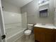 Bright bathroom featuring a shower-tub, toilet and a single sink vanity at 2520 Edgewater Falls Dr, Brandon, FL 33511