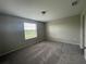 Comfortable bedroom with a large window and plush carpeting at 2520 Edgewater Falls Dr, Brandon, FL 33511