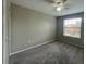 Bedroom featuring carpeting, a ceiling fan and a window for natural light at 2520 Edgewater Falls Dr, Brandon, FL 33511