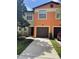 Charming townhome featuring a one car garage and colorful stucco exterior at 2520 Edgewater Falls Dr, Brandon, FL 33511