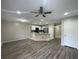 Spacious living room and kitchen combo, with modern appliances and a ceiling fan at 2520 Edgewater Falls Dr, Brandon, FL 33511