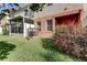 Beautiful backyard with lush green lawn and cozy screened-in patio at 263 Alexander Woods Dr, Plant City, FL 33563