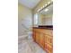 Bathroom features a light wood vanity with granite counters and tile flooring at 263 Alexander Woods Dr, Plant City, FL 33563