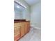 Bathroom features a light wood vanity with granite counters and tile flooring at 263 Alexander Woods Dr, Plant City, FL 33563