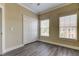 Bedroom features two windows, a closet and neutral paint, creating a serene retreat at 263 Alexander Woods Dr, Plant City, FL 33563