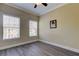 Bright bedroom with two windows, neutral walls, and modern gray floors at 263 Alexander Woods Dr, Plant City, FL 33563