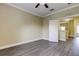 Bright bedroom features a ceiling fan, crown molding, and modern gray floors at 263 Alexander Woods Dr, Plant City, FL 33563