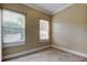The room displays neutral walls and tile flooring, plus two windows offering natural light at 263 Alexander Woods Dr, Plant City, FL 33563