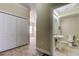 Hallway view to the powder room featuring tile floors at 263 Alexander Woods Dr, Plant City, FL 33563