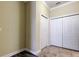 Hallway featuring tile flooring and multiple closets for ample storage space, adding practicality and convenience at 263 Alexander Woods Dr, Plant City, FL 33563