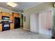 Spacious kitchen displays wood cabinets, modern black appliances and access to the patio at 263 Alexander Woods Dr, Plant City, FL 33563