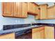 Kitchen displays wood cabinets, dark countertops, and modern appliances at 263 Alexander Woods Dr, Plant City, FL 33563