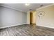 Spacious living area with elegant tile flooring, neutral paint, and stylish clock as a focal point at 263 Alexander Woods Dr, Plant City, FL 33563