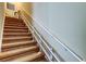 Carpeted stairway with double handrails for safety and convenience at 263 Alexander Woods Dr, Plant City, FL 33563