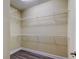 Walk-in closet with white wire shelving, neutral walls, and modern floors at 263 Alexander Woods Dr, Plant City, FL 33563