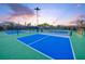 Well-lit pickleball courts for active community fun with dusk sky background at 27509 Gulf Dune Dr, Englewood, FL 34223