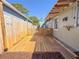 Spacious wooden deck in backyard area featuring privacy fence on both sides and small gate with yard beyond at 2869 36Th N Ave, St Petersburg, FL 33713