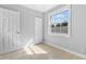 Cozy bedroom featuring a large window, tile flooring, and ample closet space at 2869 36Th N Ave, St Petersburg, FL 33713