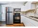Modern kitchen featuring white cabinets, stainless steel appliances, and granite countertops at 2869 36Th N Ave, St Petersburg, FL 33713