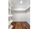 Bright walk-in closet featuring wood floors and built-in shelving for optimal storage at 2869 36Th N Ave, St Petersburg, FL 33713