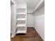 Spacious walk-in closet with custom shelving and dark wood-look flooring at 2869 36Th N Ave, St Petersburg, FL 33713