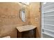 Close up of half-bathroom featuring tan tiled walls and an ornate mirror above the vanity at 2970 68Th S Ave, St Petersburg, FL 33712