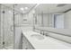 Well-lit bathroom features shower and sink with white marble countertop at 2970 68Th S Ave, St Petersburg, FL 33712
