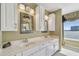 Bathroom featuring a dual vanity with white cabinets, chrome fixtures, and framed mirrors and water view at 2970 68Th S Ave, St Petersburg, FL 33712