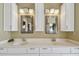 Bathroom featuring a dual vanity with white cabinets, chrome fixtures, and framed mirrors at 2970 68Th S Ave, St Petersburg, FL 33712