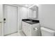Clean bathroom with a dark countertop, bright white cabinet, and white toilet at 2970 68Th S Ave, St Petersburg, FL 33712