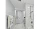 Bright bathroom with white tile, stand up shower, and a towel rack with linens at 2970 68Th S Ave, St Petersburg, FL 33712
