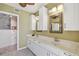 Bathroom featuring a dual vanity with white cabinets, chrome fixtures, and framed mirrors at 2970 68Th S Ave, St Petersburg, FL 33712