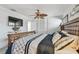 Bedroom featuring wicker bed, closet with bi-fold doors, and mounted television at 2970 68Th S Ave, St Petersburg, FL 33712