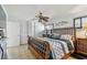 Bedroom with white walls, wicker bed, ceiling fan, and sliding closet doors at 2970 68Th S Ave, St Petersburg, FL 33712
