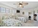 Bright bedroom featuring twin beds with ocean-themed quilts, plus shuttered windows and closet at 2970 68Th S Ave, St Petersburg, FL 33712