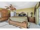 Bedroom with wicker furniture, warm lighting, and access to an outdoor balcony at 2970 68Th S Ave, St Petersburg, FL 33712