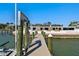 Long wooden dock leading to a modern white house with seating on an oceanfront property at 2970 68Th S Ave, St Petersburg, FL 33712