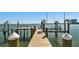Wooden dock with boat lift and wooden pillars overlooking the bay on a clear sunny day at 2970 68Th S Ave, St Petersburg, FL 33712