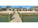 Modern house with sandy beach and boat dock with view from water on a sunny day at 2970 68Th S Ave, St Petersburg, FL 33712