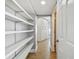 Bright hallway featuring light wood floors and ample shelving and storage space at 2970 68Th S Ave, St Petersburg, FL 33712