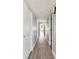 A long hallway with white-painted walls, wood floors, and several access doors at 2970 68Th S Ave, St Petersburg, FL 33712