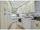 Spacious laundry room with ample cabinet space, a sink, and modern washer and dryer units at 2970 68Th S Ave, St Petersburg, FL 33712
